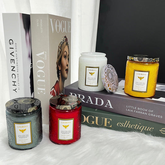 displaying scented candles 200g over stack of books as background