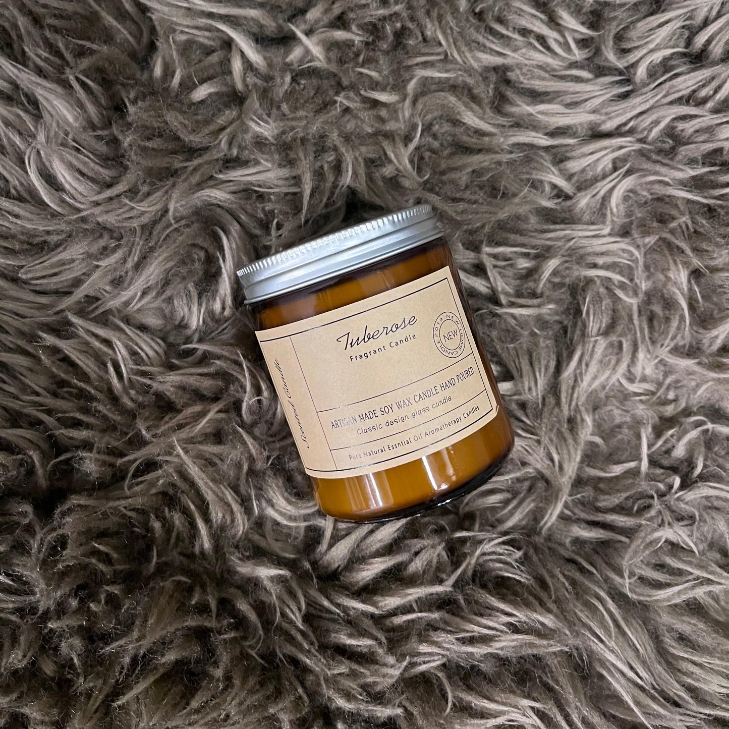 tuberose flavour scented candle over a fluffy mat