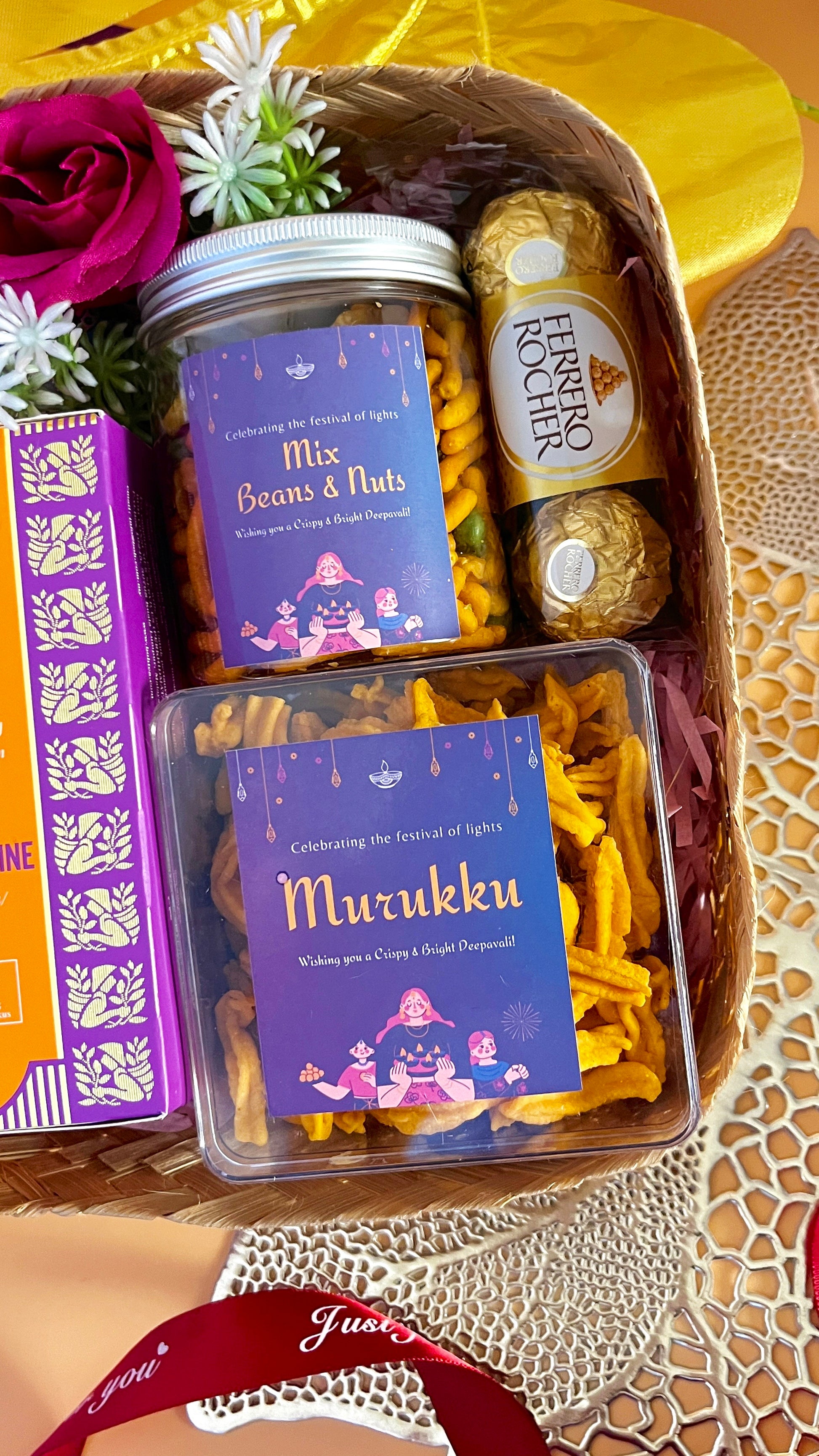 Close up shot of the transparent jar and box of deepavali snacks including mix beans and nuts and murukku with Ferrero richer chocolate