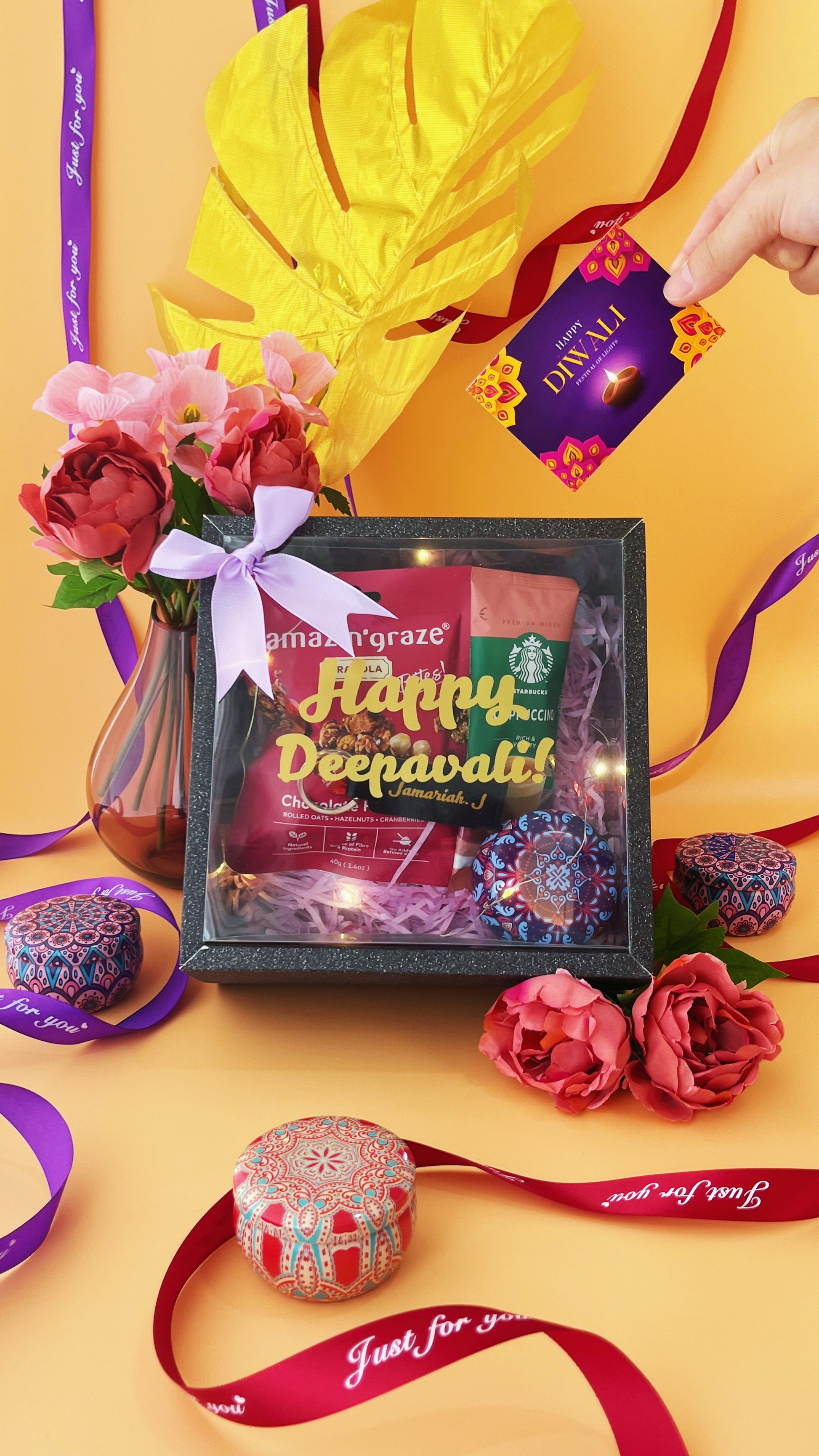 Front shot of square box deepavali gift set with colourful props